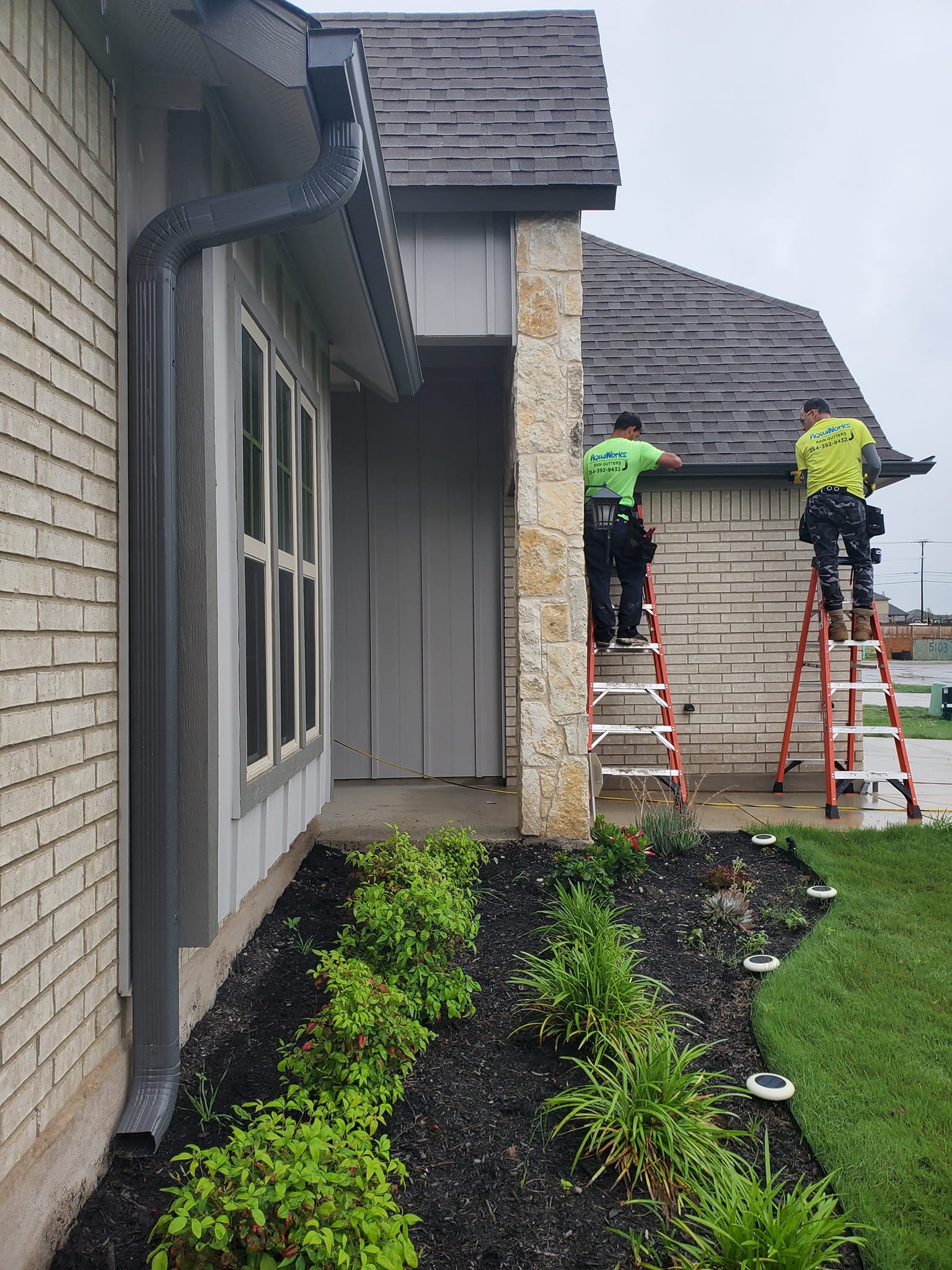 AquaWorks® Rain Gutters team installing custom gutter system