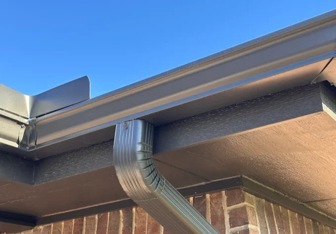 Close up view of seamless aluminum gutter system installed on roofline