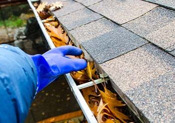 Debris buildup inside gutters showing the need for professional gutter cleaning and maintenance by AquaWorks® Rain Gutters